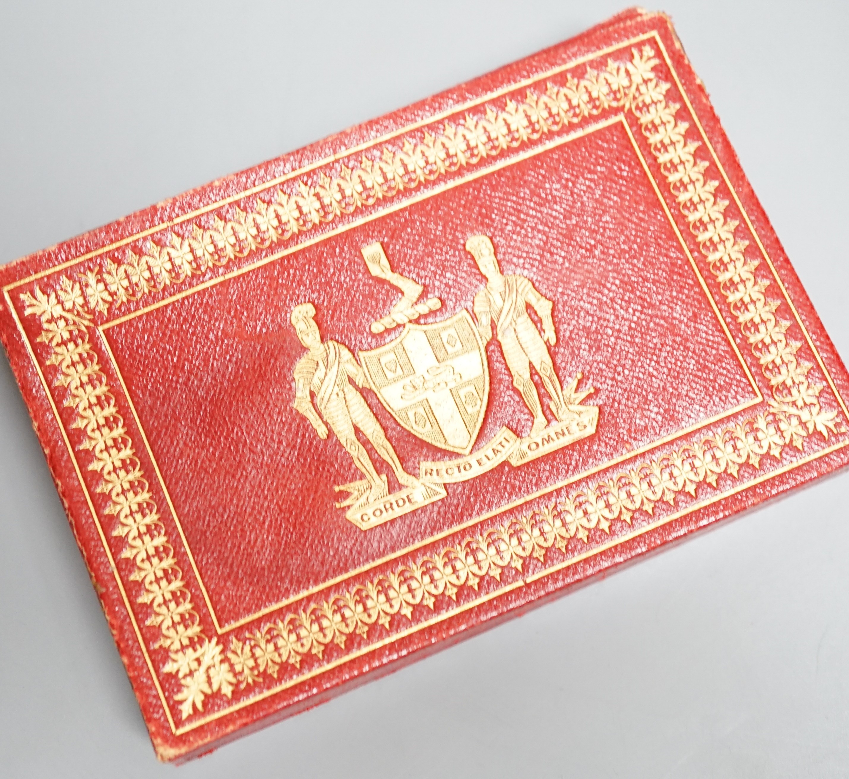 Two packs of Edwardian Royal commemorative playing cards with red morocco leather case, gilt decorated with an armorial